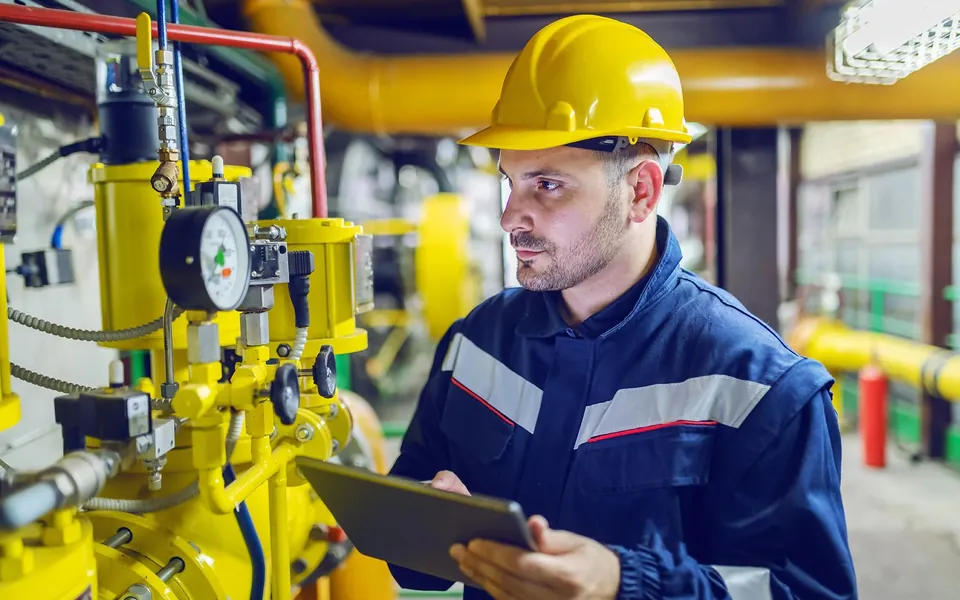 A technician checking equipment with a tablet